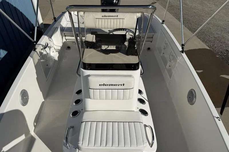 Slide: The Image of 2019 Bayliner Element E18 boat interior with seating and steering console. - 7