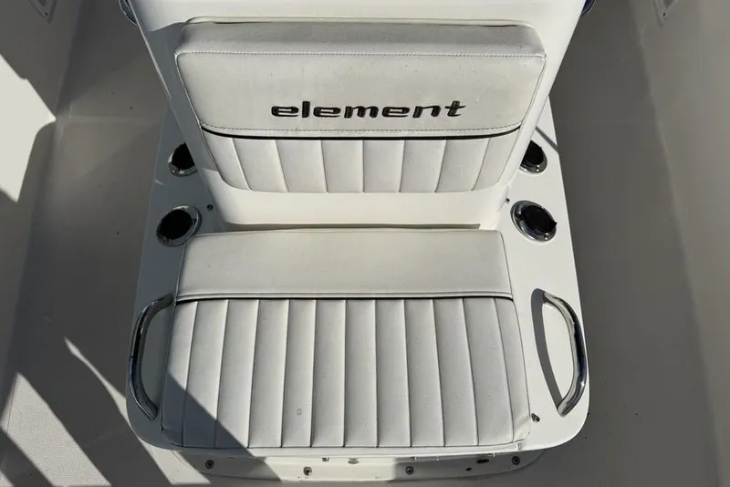 Slide: The Image of 2019 Bayliner Element E18 boat seat with "Element" logo, white upholstery, and cup holders. - 9