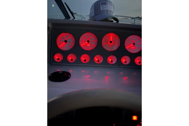 Slide: The Image of Dashboard of a 2000 Formula 31 Performance Cruiser with illuminated red gauges. - 3