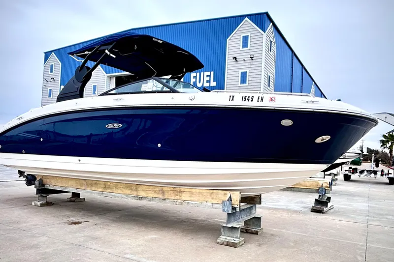 The Image of 2018 Sea Ray SDX 270 boat on display, blue hull, marina background. - 0