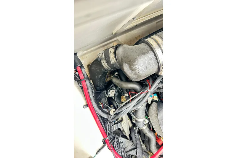 Slide: The Image of Engine compartment of a 2018 Sea Ray SDX 270 boat, showing hoses and wiring. - 22