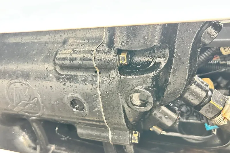 Slide: The Image of Close-up of 2018 Sea Ray SDX 270 engine component with visible bolts and wiring. - 23