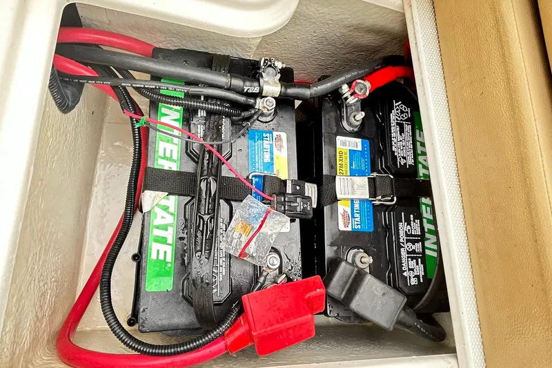 Slide: The Image of 2018 Sea Ray SDX 270 boat battery compartment with Interstate batteries and wiring. - 25