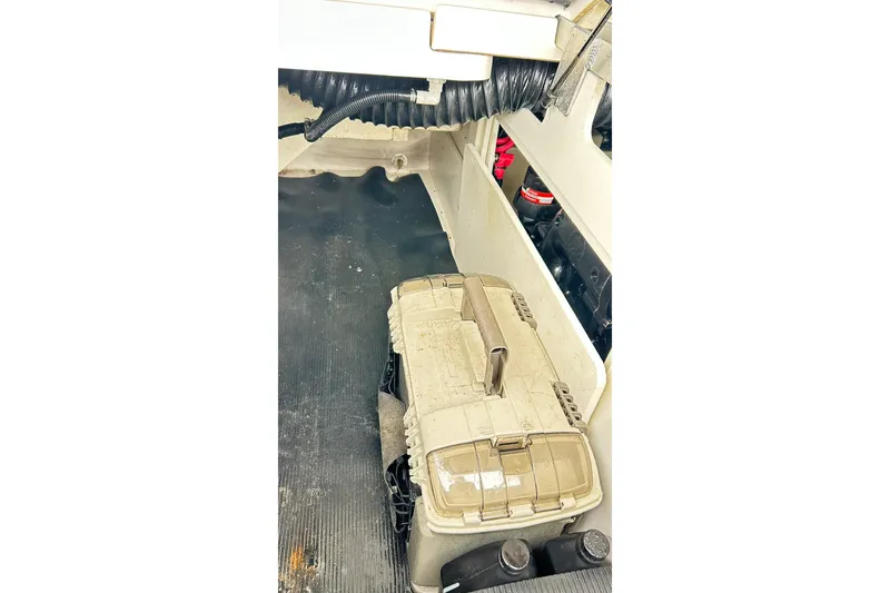 Slide: The Image of 2018 Sea Ray SDX 270 storage compartment with equipment and wiring. - 27