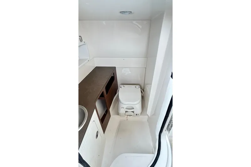 Slide: The Image of 2018 Sea Ray SDX 270 boat interior bathroom with toilet and sink. - 35