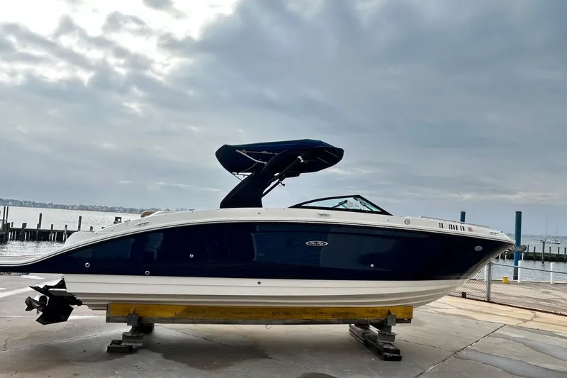 Slide: The Image of 2018 Sea Ray SDX 270 boat on a dock with cloudy sky background. - 38