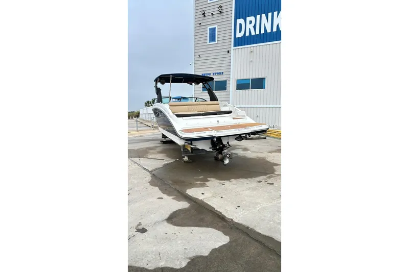 Slide: The Image of 2018 Sea Ray SDX 270 boat on trailer near a building. - 40