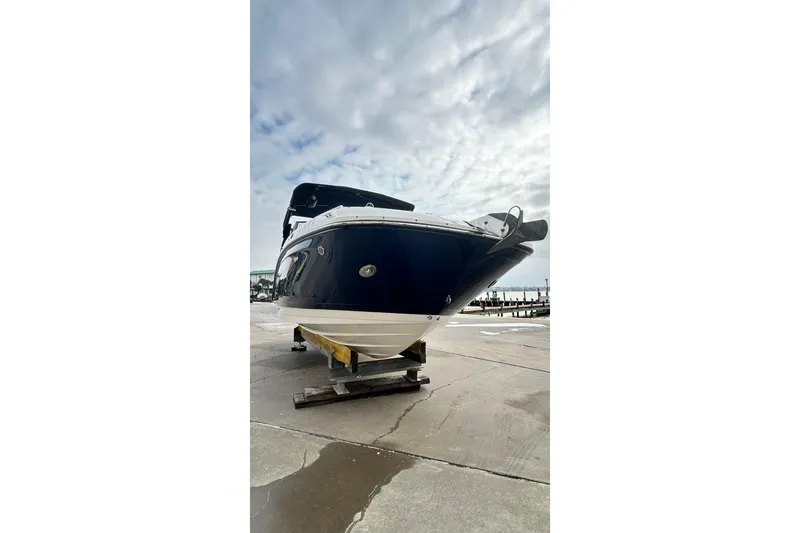 Slide: The Image of 2018 Sea Ray SDX 270 boat on a dock under a cloudy sky. - 43