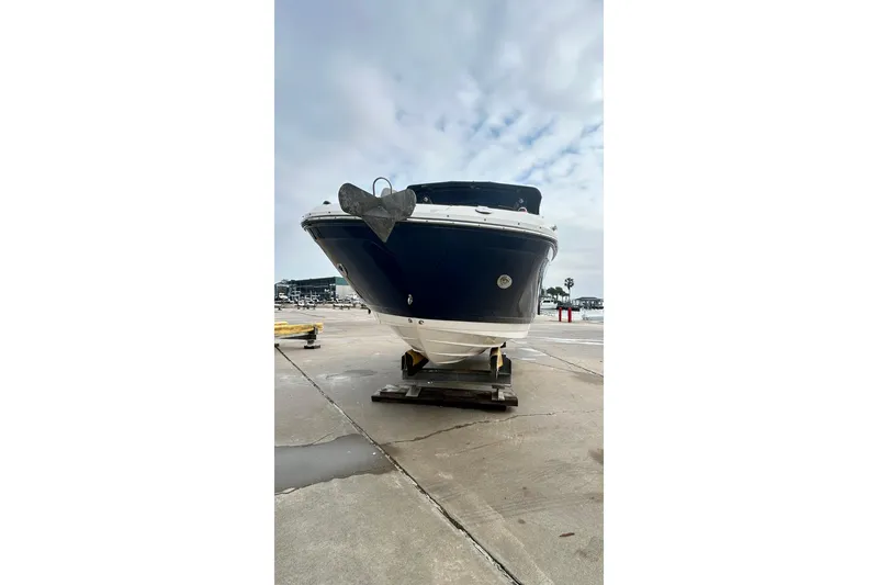 Slide: The Image of 2018 Sea Ray SDX 270 boat on a dock, under a cloudy sky. - 44