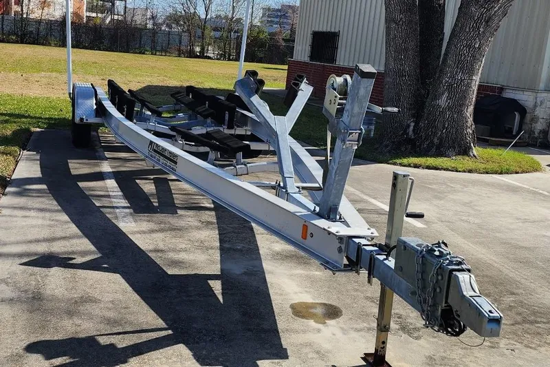 Slide: The Image of Boat trailer for 2018 Sea Ray SDX 270 parked on concrete driveway. - 47