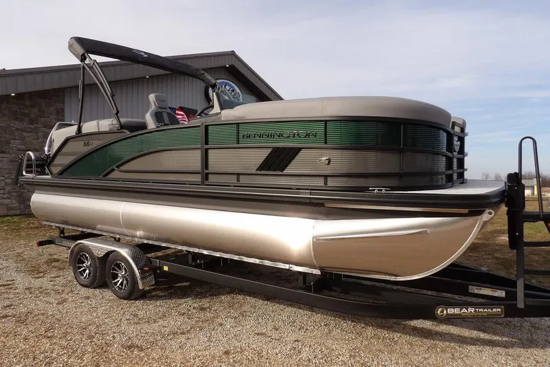 The Image of 2026 Bennington M Quad Bench 22 MFB pontoon boat on trailer, side view. - 1