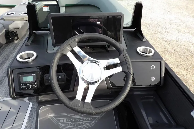 Slide: The Image of 2026 Bennington M Quad Bench 22 MFB boat dashboard with steering wheel and controls. - 21