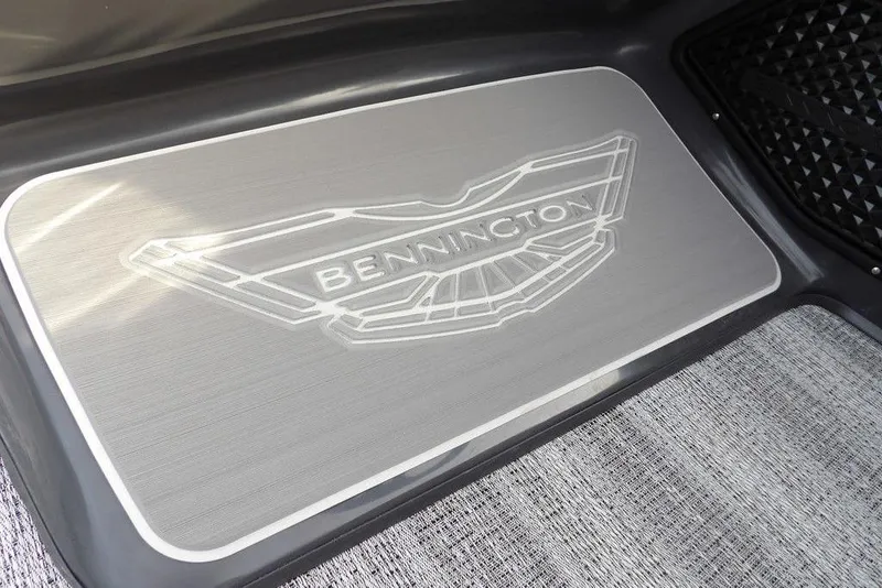 Slide: The Image of Bennington M Quad Bench 22 MFB 2026 logo on sleek boat flooring. - 23