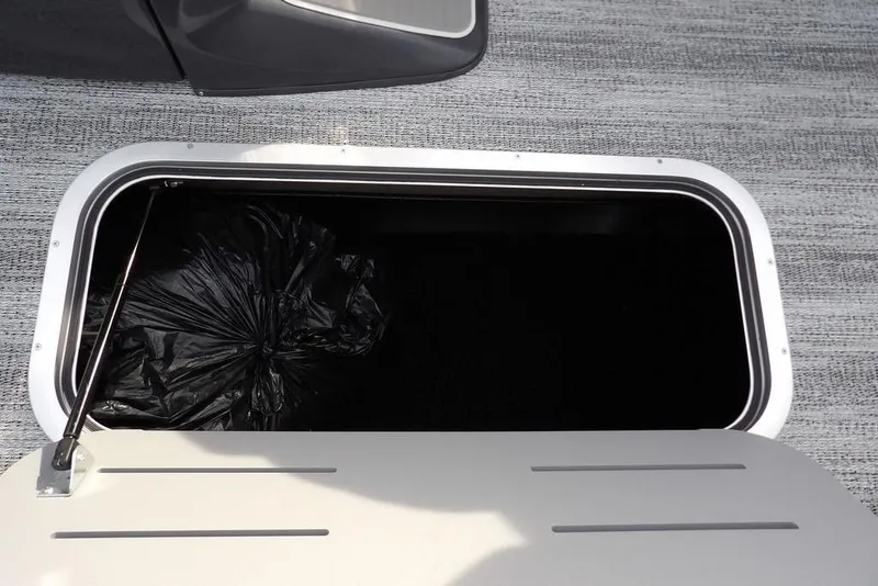 Slide: The Image of Open storage compartment in 2026 Bennington M Quad Bench 22 MFB boat. - 28