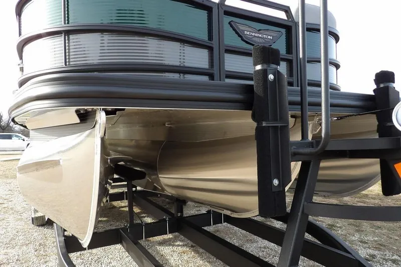 Slide: The Image of 2026 Bennington M Quad Bench 22 MFB pontoon boat on trailer, close-up view. - 33