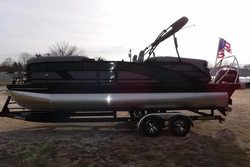 Slide: The Image of 2026 Bennington M Quad Bench 22 MFB pontoon boat on trailer, side view. - 6