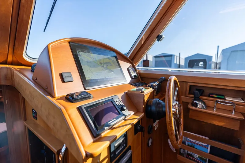 Slide: The Image of 2013 Sabre 38 Salon Express helm with navigation screens and wooden steering wheel. - 15