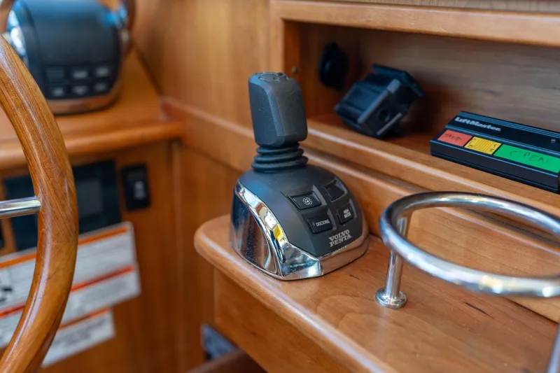 Slide: The Image of 2013 Sabre 38 Salon Express helm with joystick control and wooden steering wheel. - 19