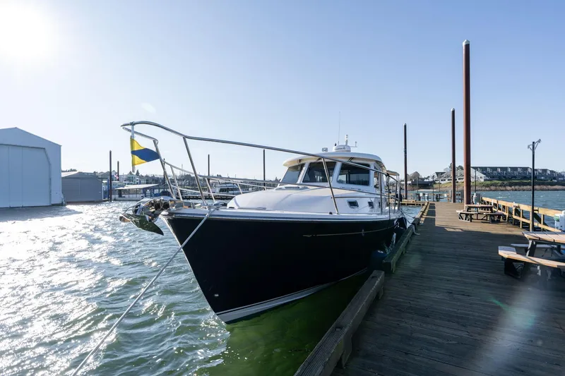Slide: The Image of 2013 Sabre 38 Salon Express yacht docked at a sunny marina. - 2