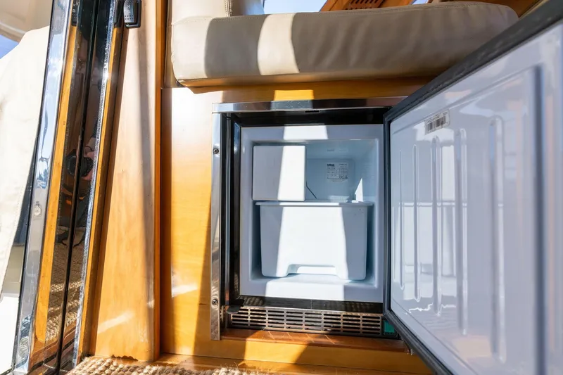 Slide: The Image of Open refrigerator on 2013 Sabre 38 Salon Express yacht, showcasing interior storage space. - 22