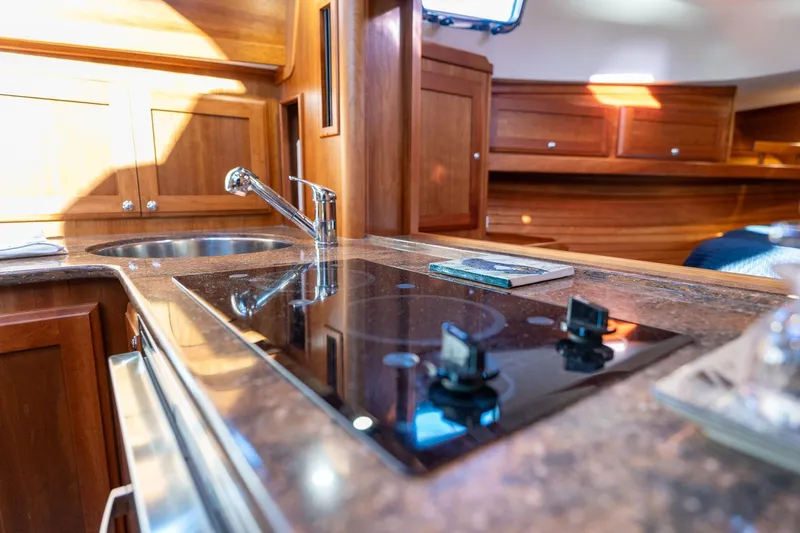 Slide: The Image of Interior of 2013 Sabre 38 Salon Express yacht kitchen with stove and sink. - 26