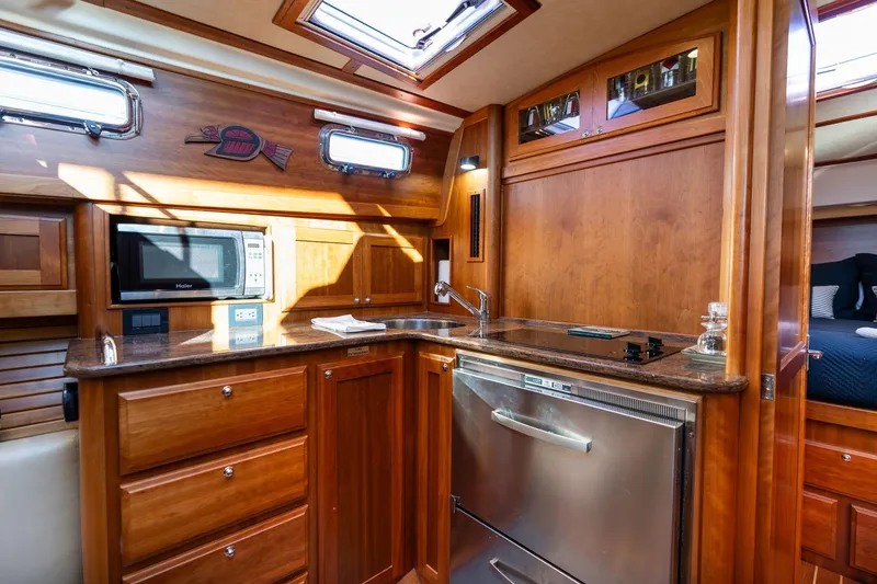 Slide: The Image of Luxurious 2013 Sabre 38 Salon Express yacht interior with modern kitchen amenities. - 28