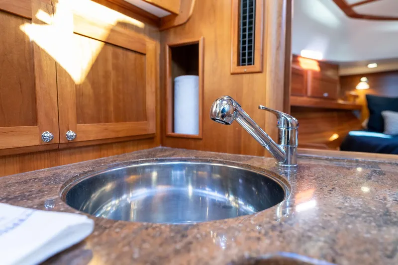 Slide: The Image of 2013 Sabre 38 Salon Express yacht interior with polished sink and wooden cabinetry. - 29
