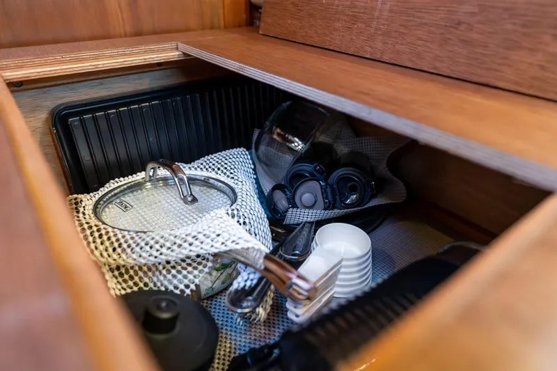 Slide: The Image of Storage compartment in 2013 Sabre 38 Salon Express, featuring cookware and kitchen items. - 34