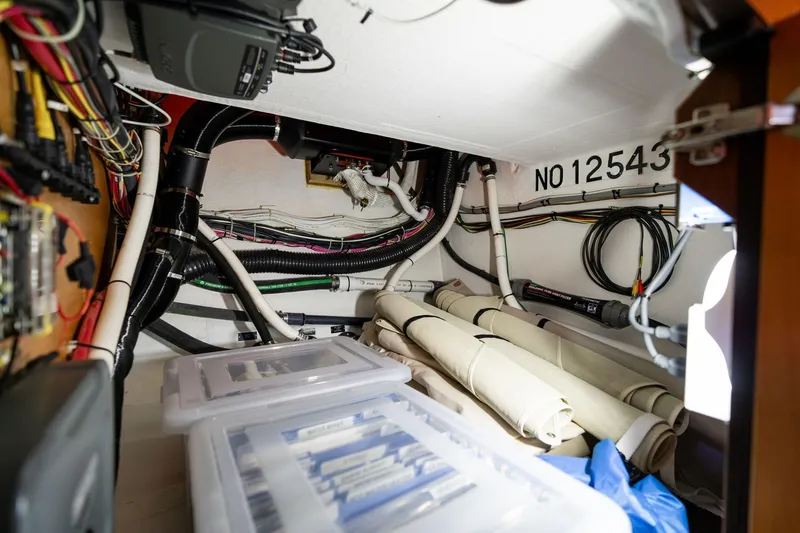 Slide: The Image of 2013 Sabre 38 Salon Express interior wiring and storage area with organized cables and equipment. - 36