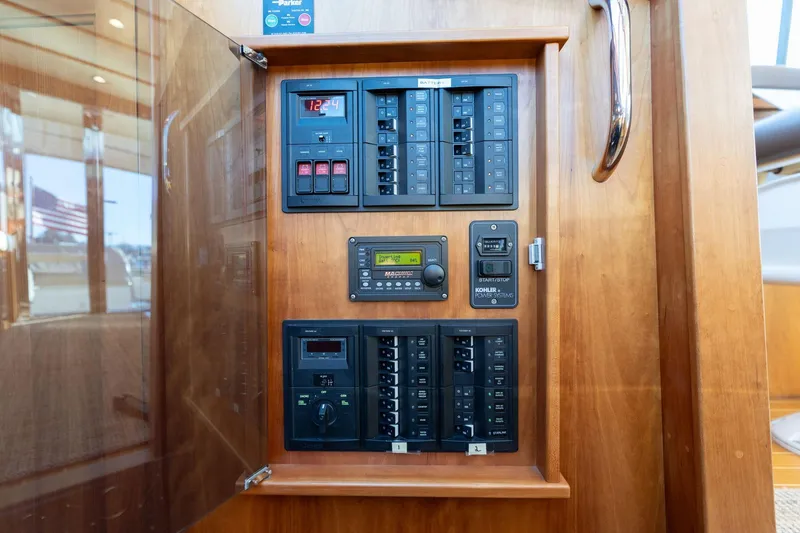 Slide: The Image of Electrical panel inside 2013 Sabre 38 Salon Express yacht, featuring control switches and displays. - 38