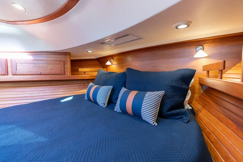 Slide: The Image of Luxurious cabin interior of 2013 Sabre 38 Salon Express with blue bedding and wooden accents. - 43