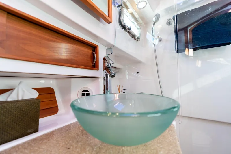 Slide: The Image of Luxurious bathroom interior of 2013 Sabre 38 Salon Express yacht with glass sink and wooden accents. - 46