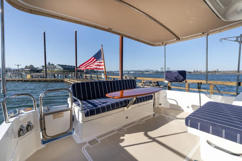 Slide: The Image of 2013 Sabre 38 Salon Express yacht interior with striped seating and American flag. - 50