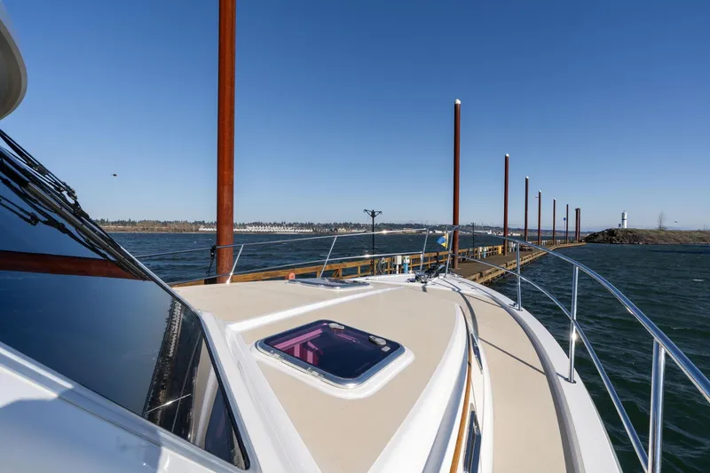 Slide: The Image of 2013 Sabre 38 Salon Express yacht docked by a scenic waterfront. - 53