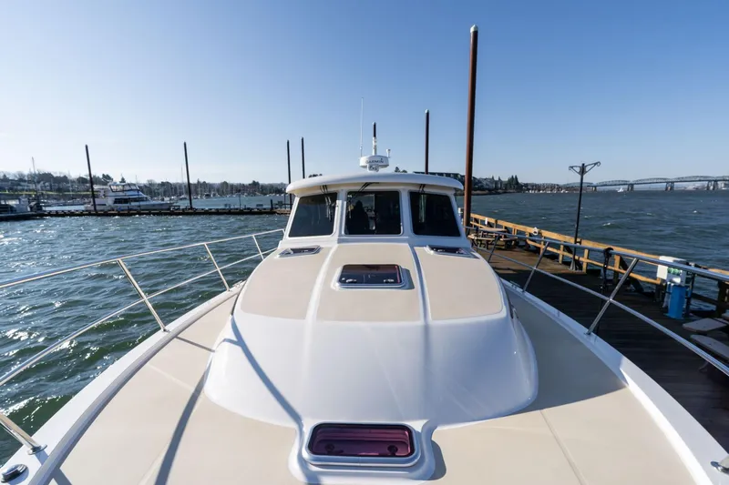 Slide: The Image of 2013 Sabre 38 Salon Express yacht docked by a scenic waterfront. - 55