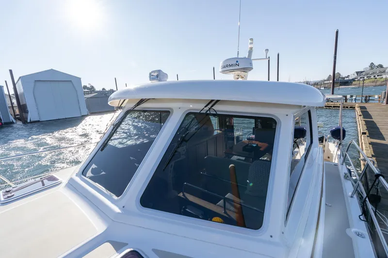 Slide: The Image of 2013 Sabre 38 Salon Express yacht docked, featuring Garmin equipment and sleek design. - 56