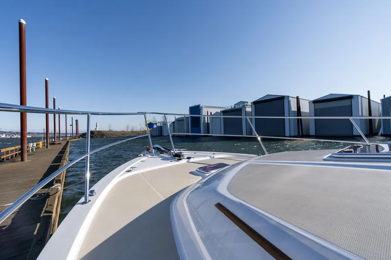 Slide: The Image of 2013 Sabre 38 Salon Express yacht docked near waterfront buildings. - 57