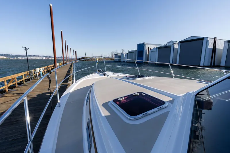Slide: The Image of 2013 Sabre 38 Salon Express yacht docked at marina with clear blue sky. - 58