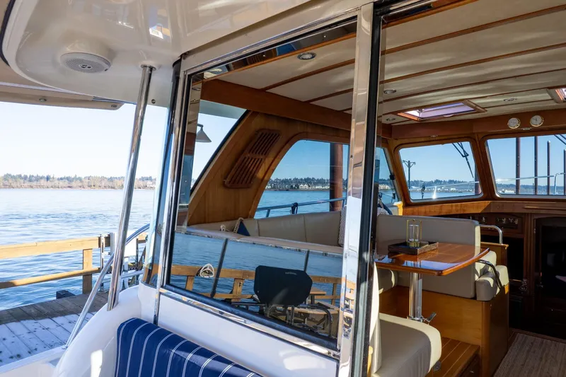 Slide: The Image of Interior view of 2013 Sabre 38 Salon Express yacht with elegant wood finish and waterfront backdrop. - 6