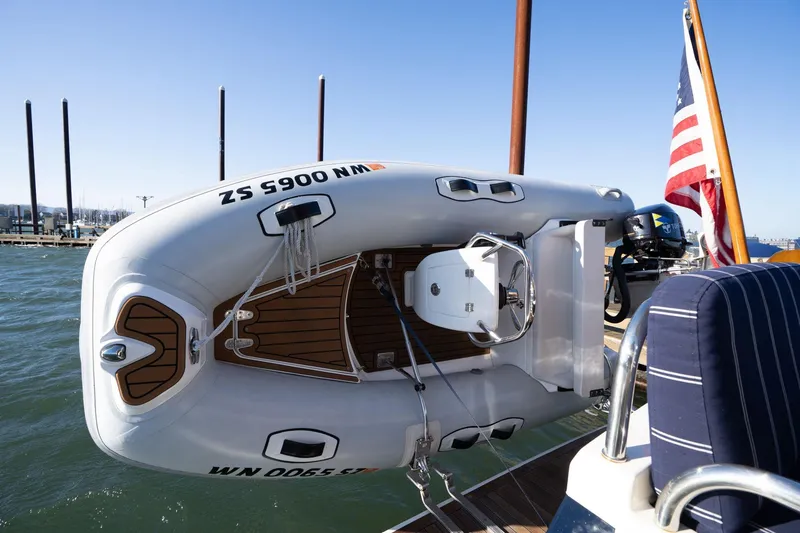 Slide: The Image of 2013 Sabre 38 Salon Express with dinghy and American flag on deck. - 62