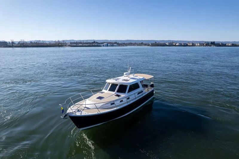 Slide: The Image of 2013 Sabre 38 Salon Express cruising on a calm, scenic waterway. - 71