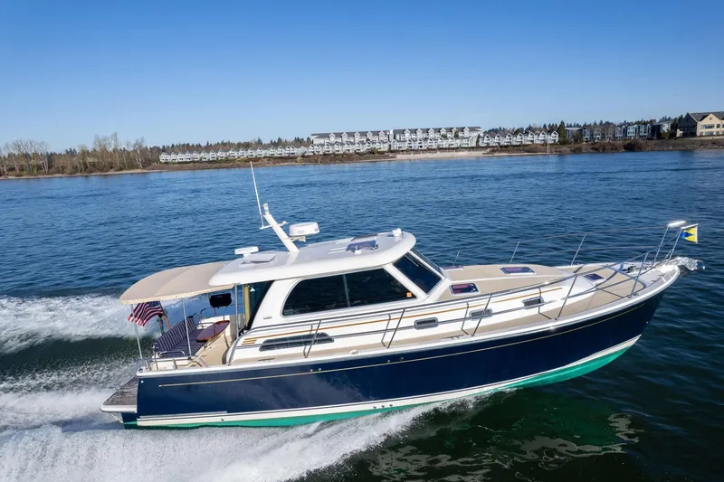 Slide: The Image of 2013 Sabre 38 Salon Express cruising on a sunny day near shoreline. - 73