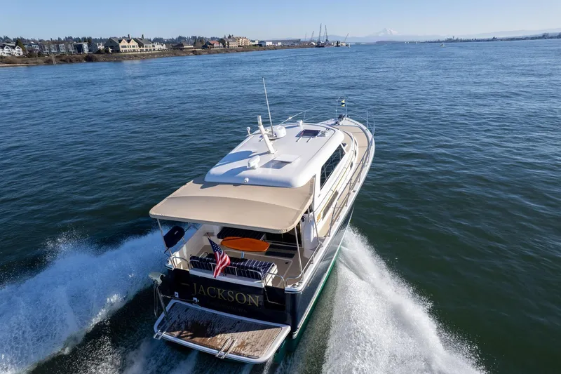 Slide: The Image of 2013 Sabre 38 Salon Express cruising on open water, rear view. - 75