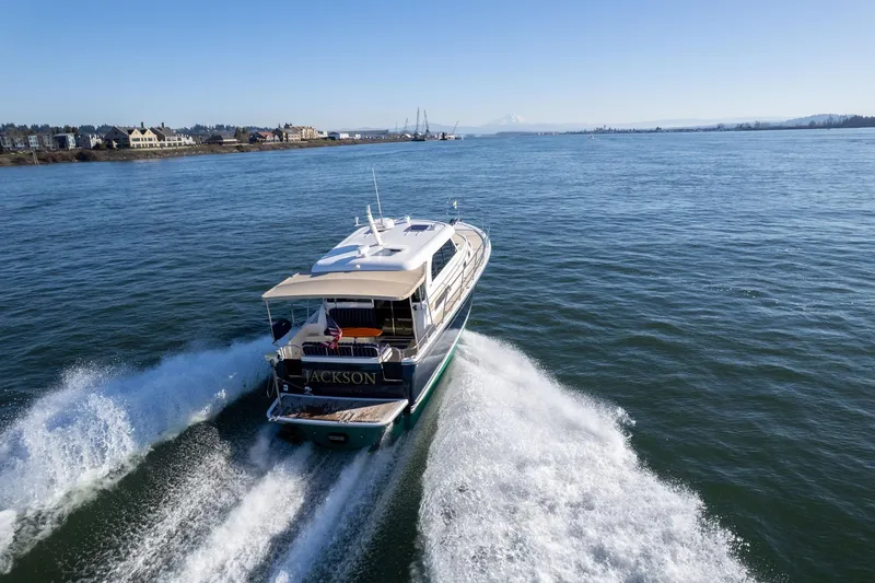 Slide: The Image of 2013 Sabre 38 Salon Express cruising on open water, creating a wake. - 76