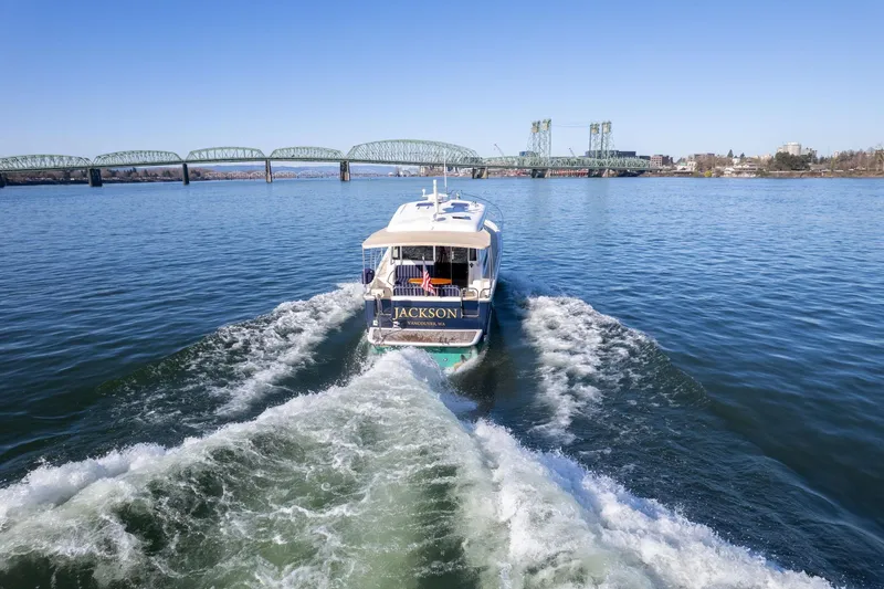Slide: The Image of 2013 Sabre 38 Salon Express cruising on a river with a bridge in the background. - 77