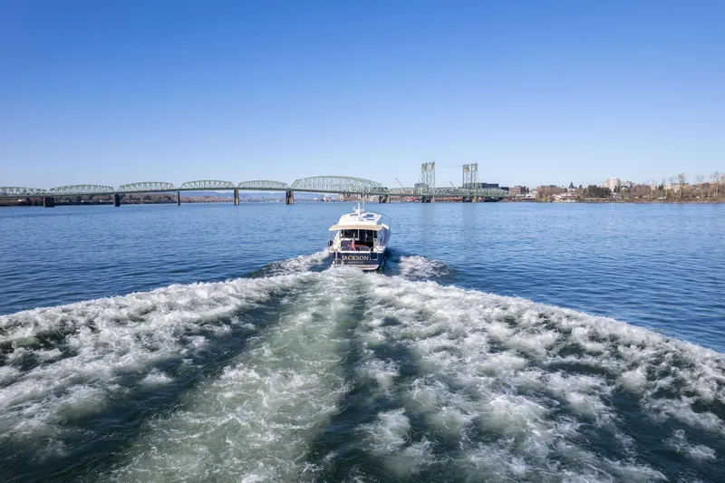 Slide: The Image of 2013 Sabre 38 Salon Express cruising on a river with a bridge in the background. - 78