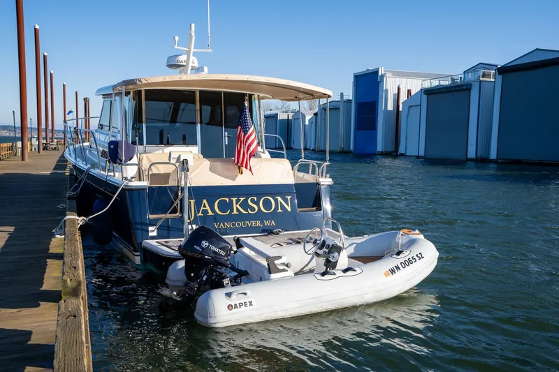 Slide: The Image of 2013 Sabre 38 Salon Express docked with inflatable boat, American flag displayed. - 83