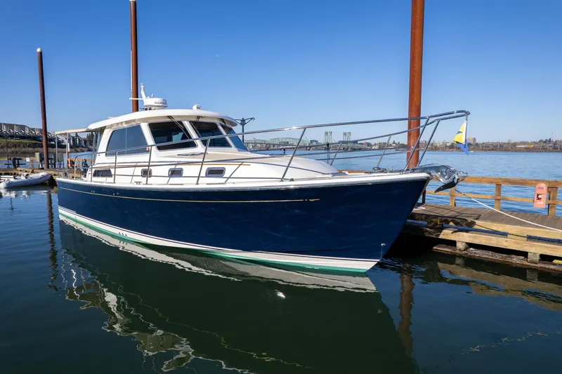 Slide: The Image of 2013 Sabre 38 Salon Express yacht docked at a marina on a sunny day. - 85