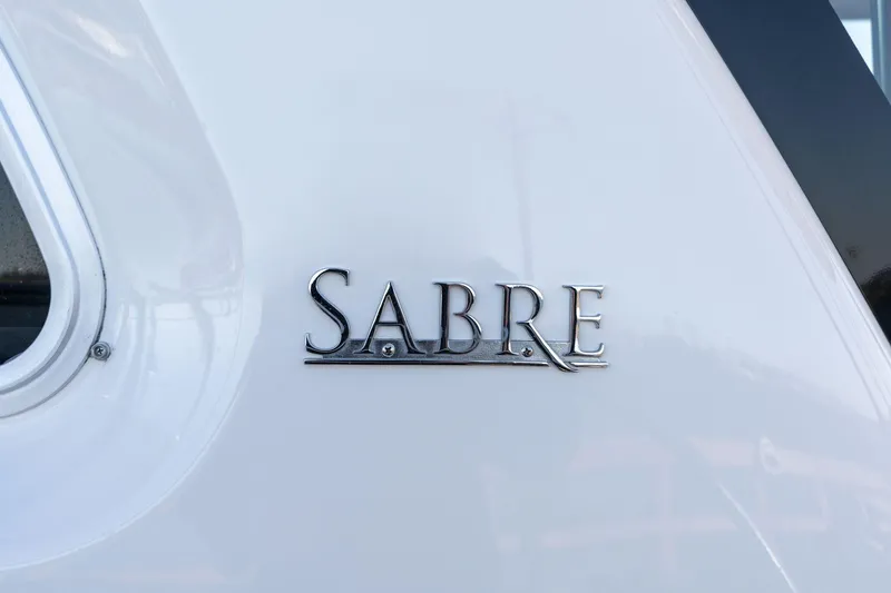 Slide: The Image of 2013 Sabre 38 Salon Express logo on white boat exterior. - 86