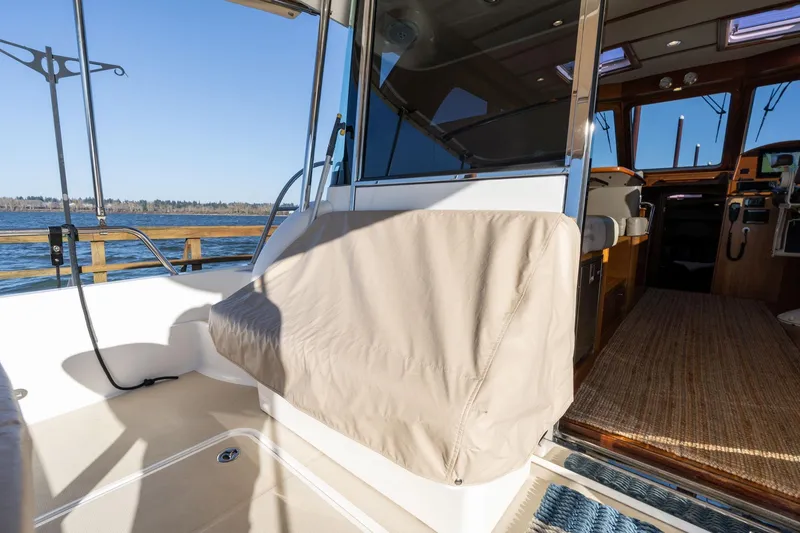 Slide: The Image of 2013 Sabre 38 Salon Express yacht interior with covered seating and open cabin view. - 87